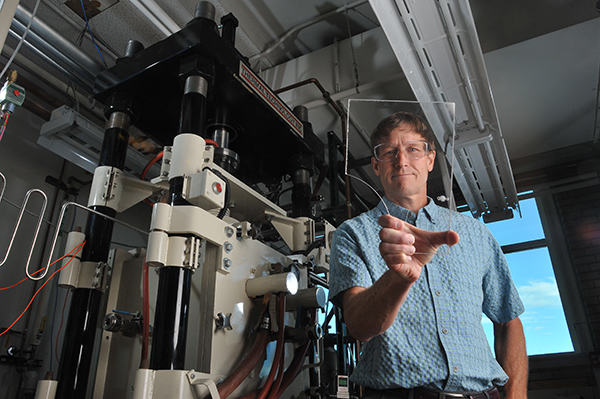 Professor Ivar Reimanis looks through a piece of glass