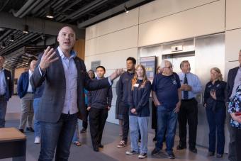 Zack Bennett leads a tour during opening of Beck