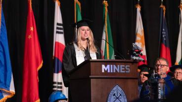 Student speaker at podium at undergrad commencement