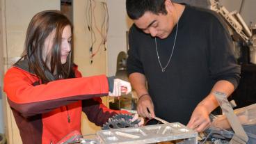 Mechanical engineering student Kaitlyn Martin and electrical engineering student Eduardo Urquidi Junior are taking apart last year's rover.