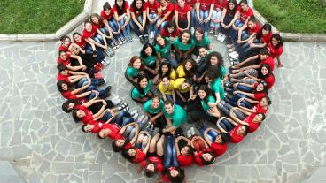 Peace Corps volunteers join Armenian women and counselors to form a heart shape during a Girls Leading Our World Camp in 2013.