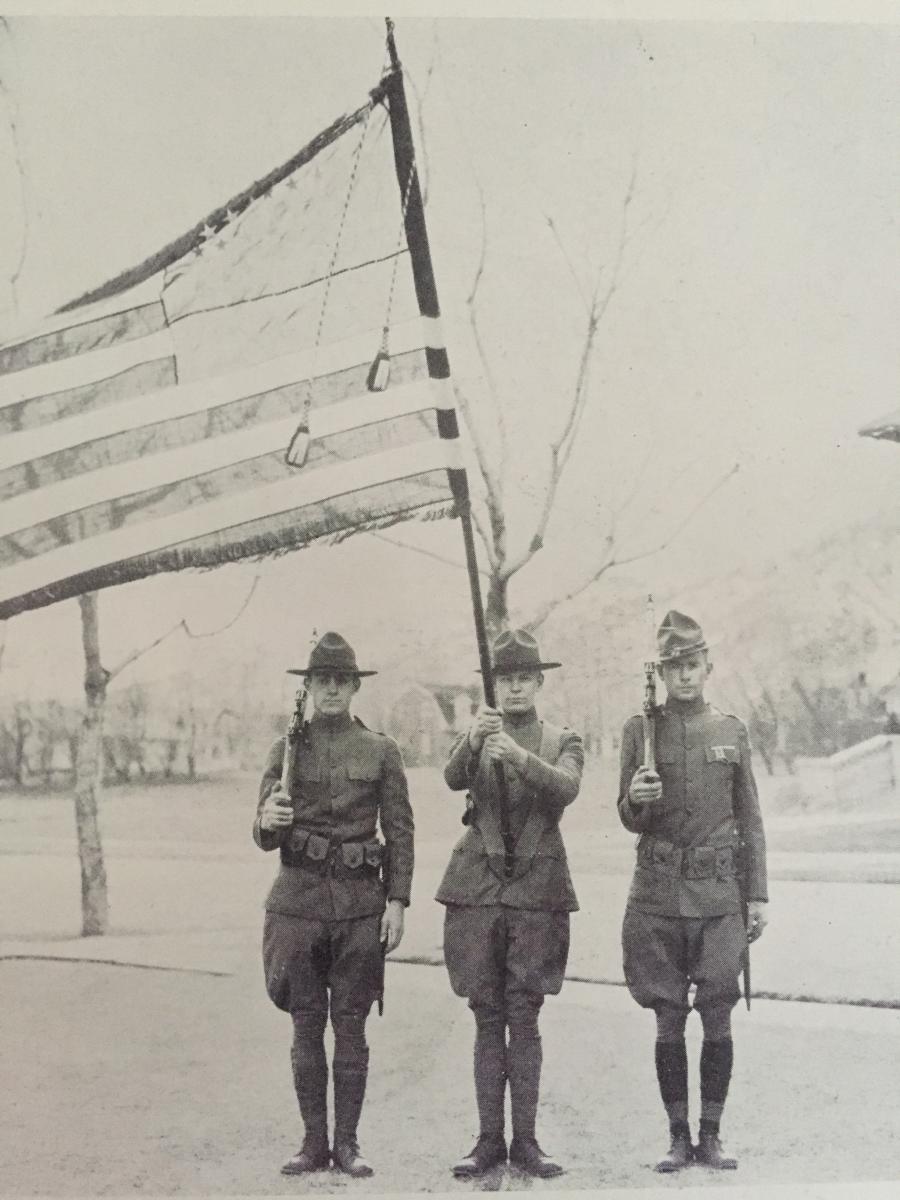 Three Mines ROTC cadets hold the American flag in 1925.