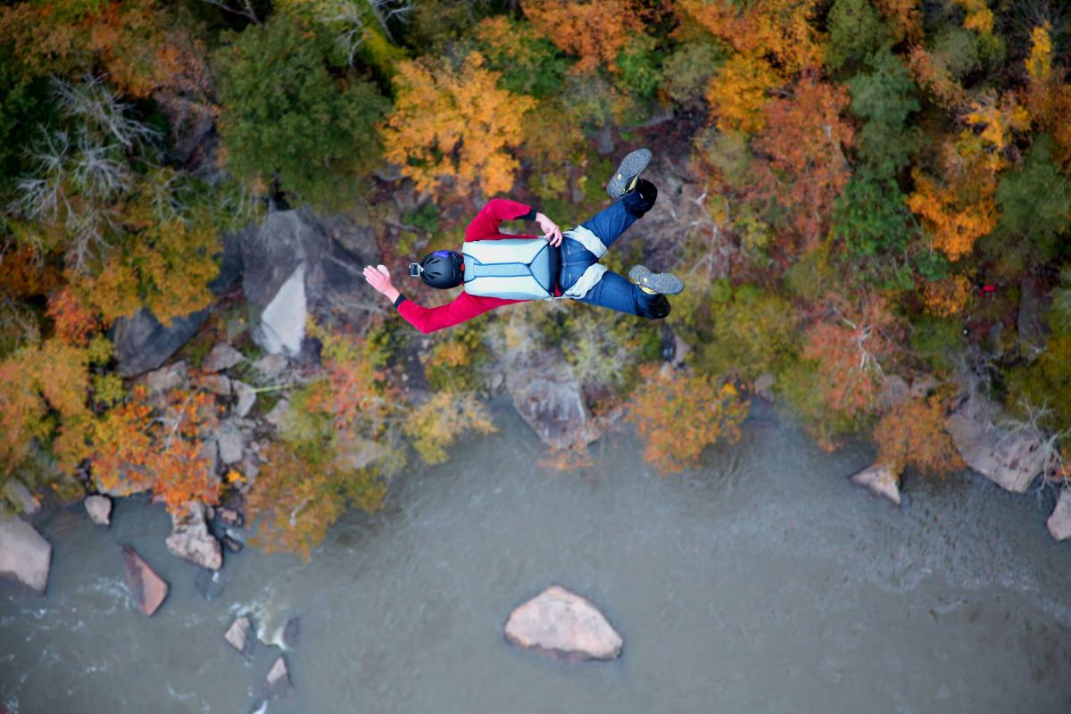 Chris Fehn BASE jumps above a river in West Virginia