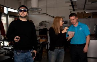 PhD student Doga Cagdas Demirkan tests out AR glasses as Professors Sebnem Duzgun and Andrew Petruska watch the feed.