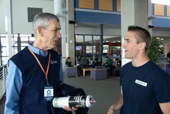 President Paul C. Johnson runs into Keenan Willits, mechanical engineering 2019, now a manufacturing engineer at Jabil here to recruit more excellent engineers