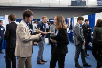 Allison Tanner, electrical engineering, runs into a friend on the recruiter floor