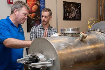 Professor Chris Dreyer works with a student in the Center for Space Resources lab