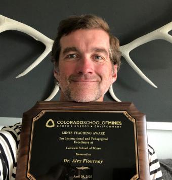 Alex Flournoy with award plaque