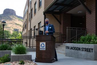 President Paul C Johnson speaks in front of 1750 Jackson