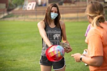 Female student gets hardhat spray painted