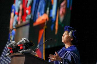 Stefanie Tompkins speaks from stage at commencemnt