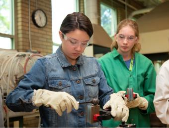 Girl pours metal in the Mines foundry