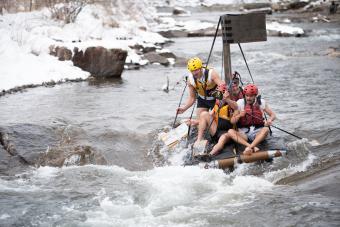 Students on a cardboard boat in Clear Creek