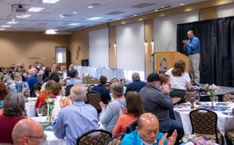 Provost Rick Holz claps at Faculty Awards Celebration