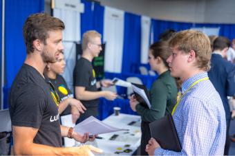 Student talks to recruiter at Career Day