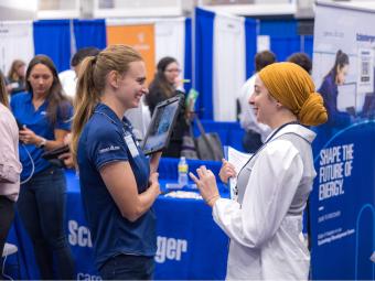 Student talks to recruiter at Career Day