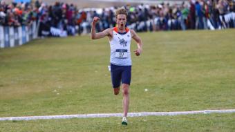 Dillon Powell runs across the finish line