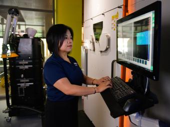 Professor Xiaoli Zhang works on a computer