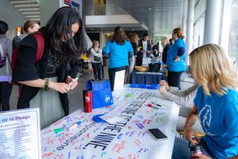 Student signs Nine out of Ten Pledge at 2022 Fresh Check Day