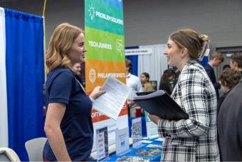 Female student talks with female recruiter