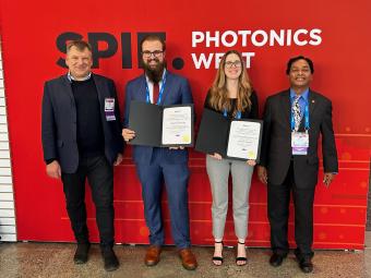 Students posing with award certificates at Photonics West