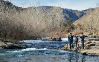 Mines researchers standing on banks of Clear Creek