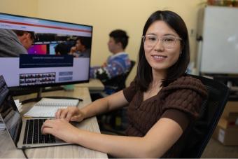 Qi Li working on a computer