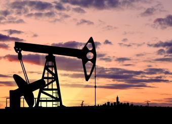 Stock image of oil pump at sunset