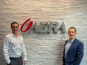 Nicholas Clausnitzer and Michael Dixon in front of Aera sign