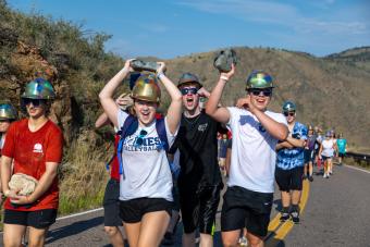 Students carry rocks up Mount Zion