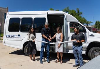 City and university officials cut the ribbon in front of Ore Cart