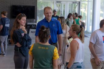 Provost Rick Holz talks with students at symposium