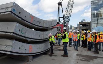 people in vests on a heavy construction work site