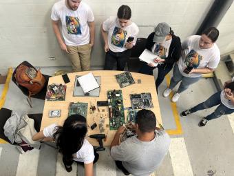 Students work with residents in Colombia on e-waste recycling