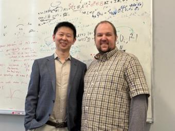 Xhexuan Gong and Casey Haack in front of whiteboard