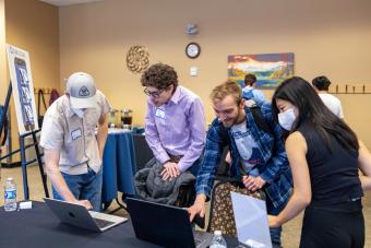 students gathered around computers