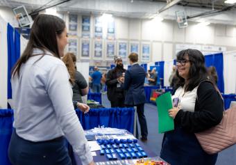 Computer science student speaks to recruiters during Spring Career Days