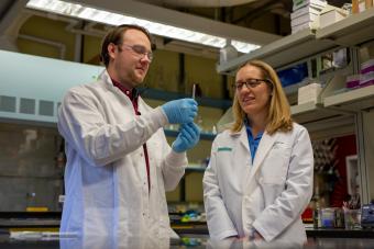 Melissa Krebs works in the lab with a student