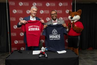 President Johnson and President Brownlee posing with t-shirts
