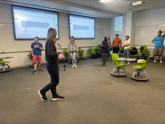 group of students stand in classroom
