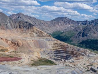 Aerial photo of the Climax Mine in Colorado with white clouds in a blue sky.