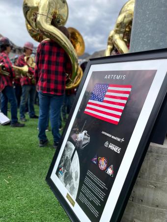 framed american flag memento and patches sitting on ground