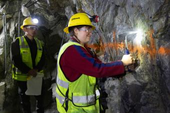 Rick Lu and Lanie Smith take samples from a supported rock face in Edgar Mine.