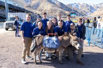 Blue Key students standing behind Blaster the Burro