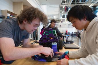 two male students work on rc car