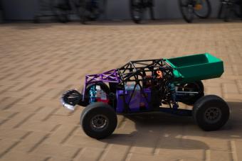 rc car driving on tan brick pavers