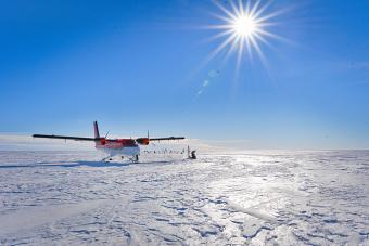 plane parked on antarctic ice with bright sun (Surface over Mercer Subglacial Lake in Antarci (Photo by Philipp Arndt)