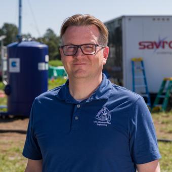 headshot of chris higgins in field