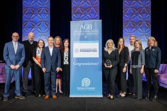 group shot of people holding an award on stage