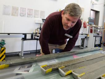 Brandon dugan looks at cores in lab